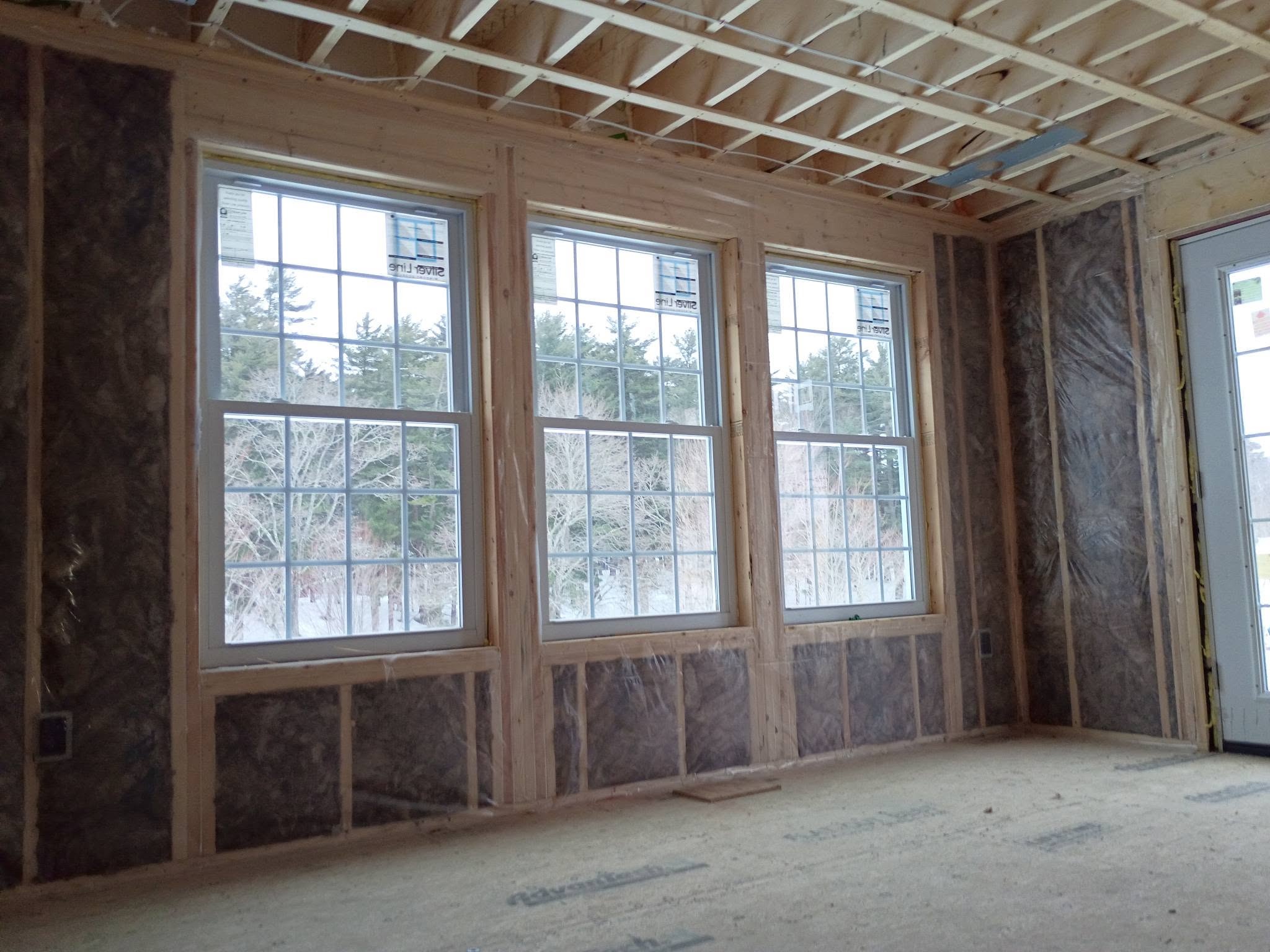 Framed room with fiberglass batt insulation and vapor barrier in Amesbury Massachusetts