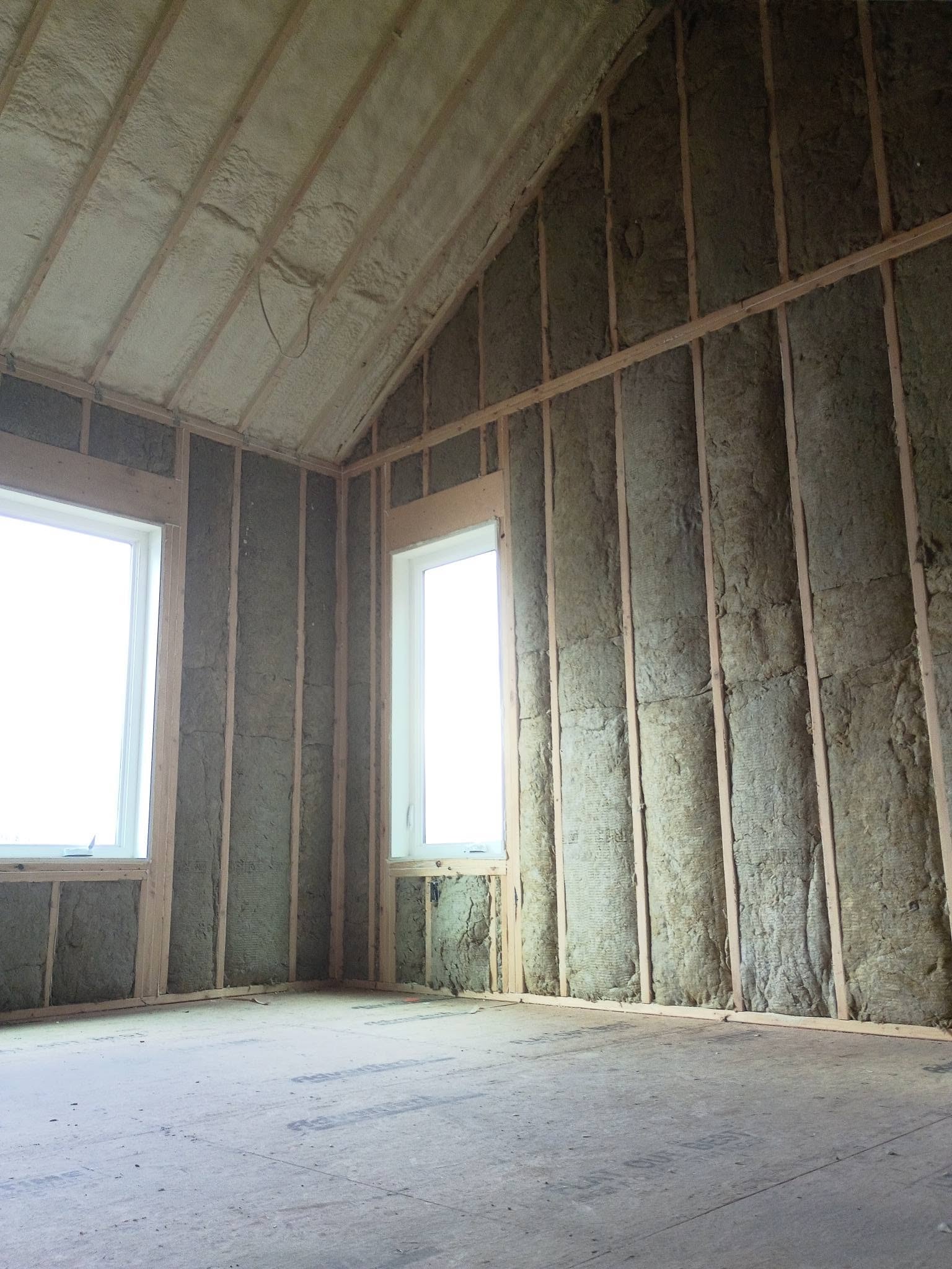Spray foam roofline with fiberglass batt wall insulation in a New Hampshire lakehouse