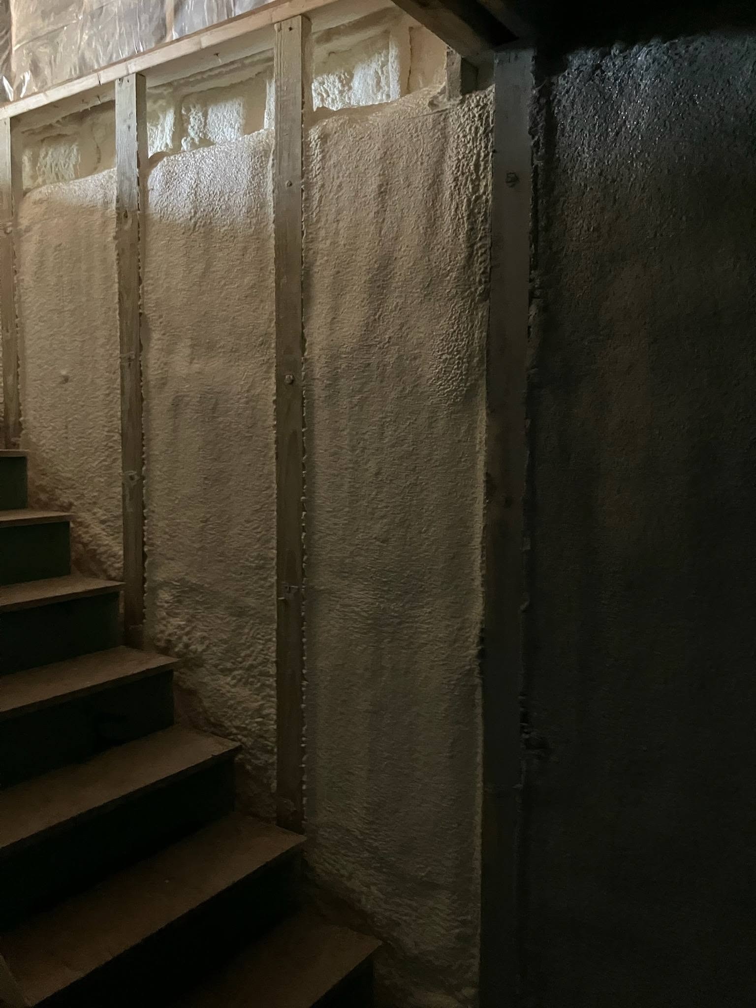 Spray foam insulation detail in a New Hampshire new home stairwell