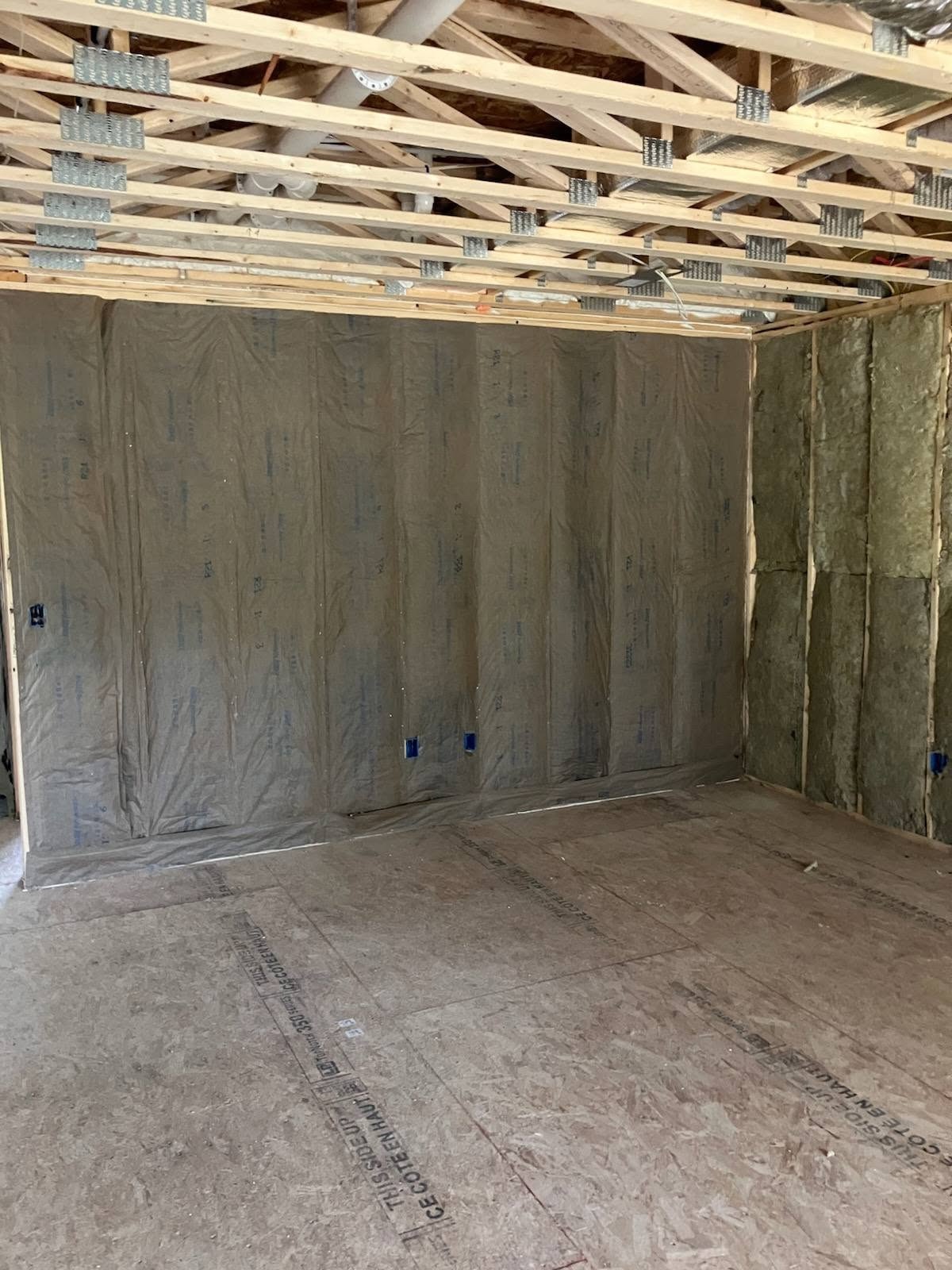 Wall insulation and vapor barrier installation in a New Hampshire new home