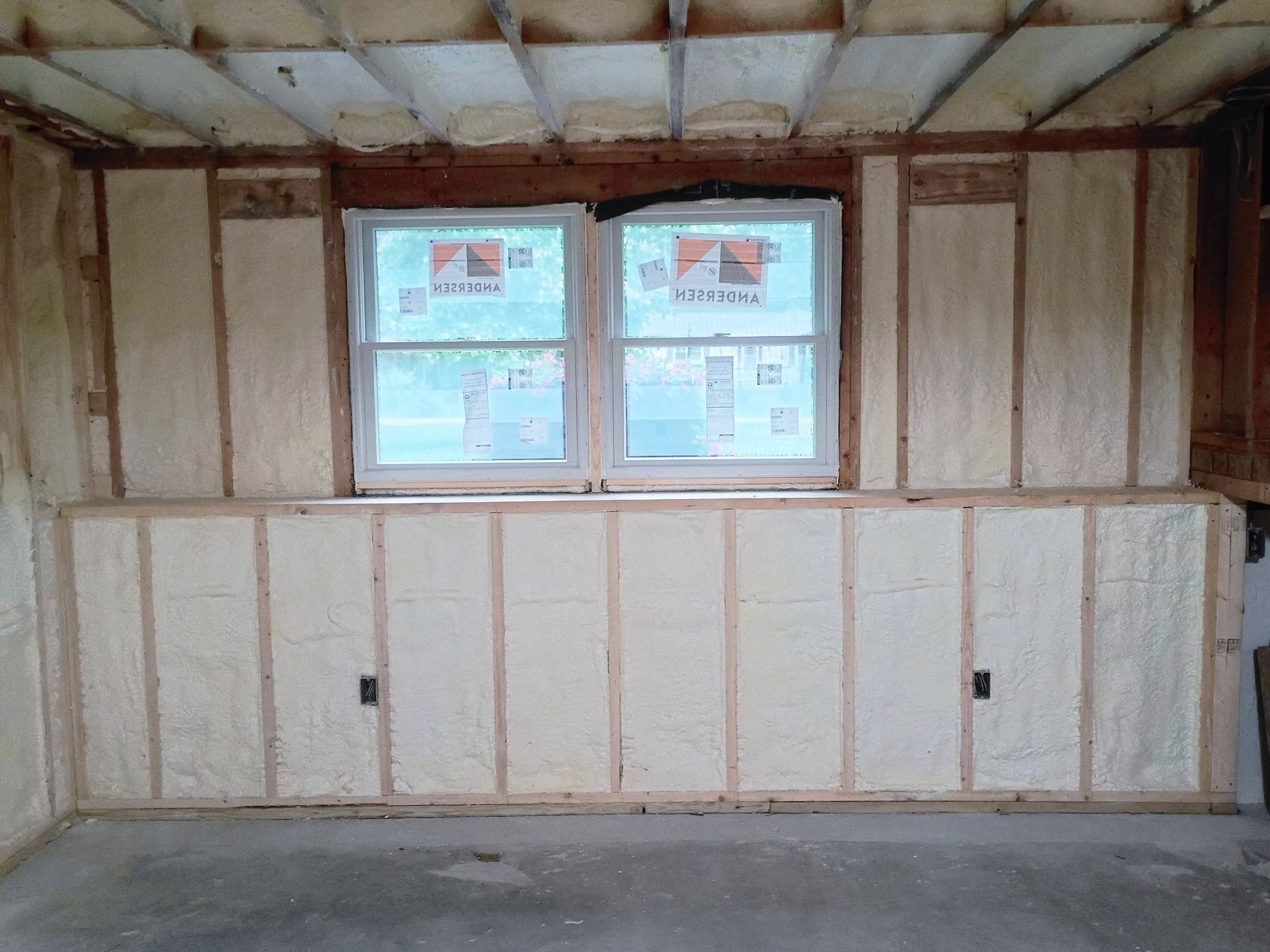 Spray foam insulation around framed wall and window openings in New Hampshire